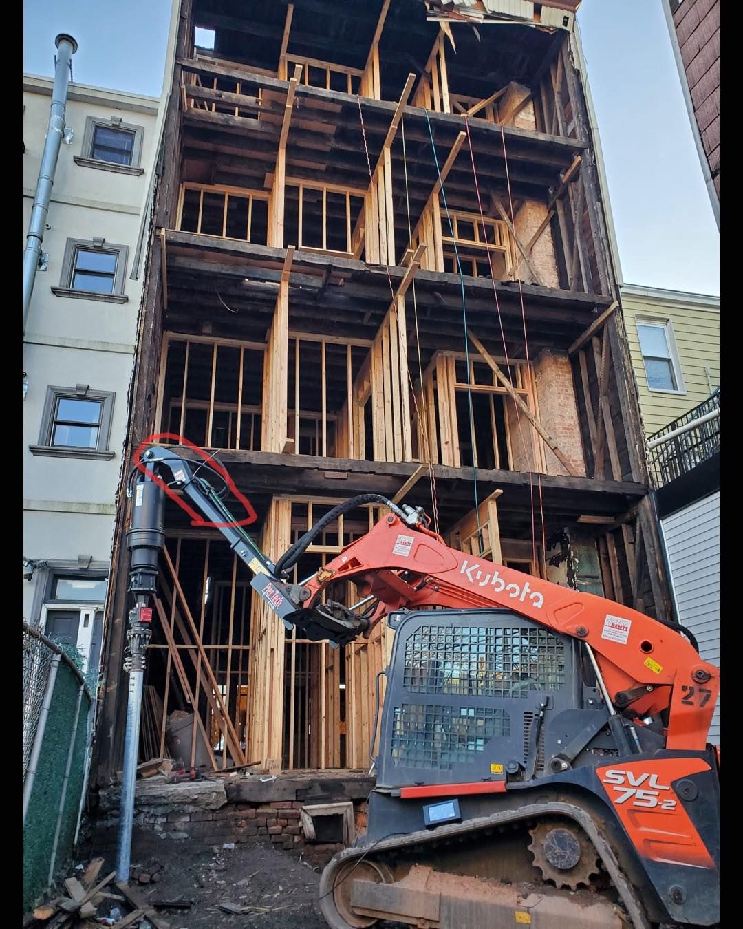 Helical pile installation inside a structure